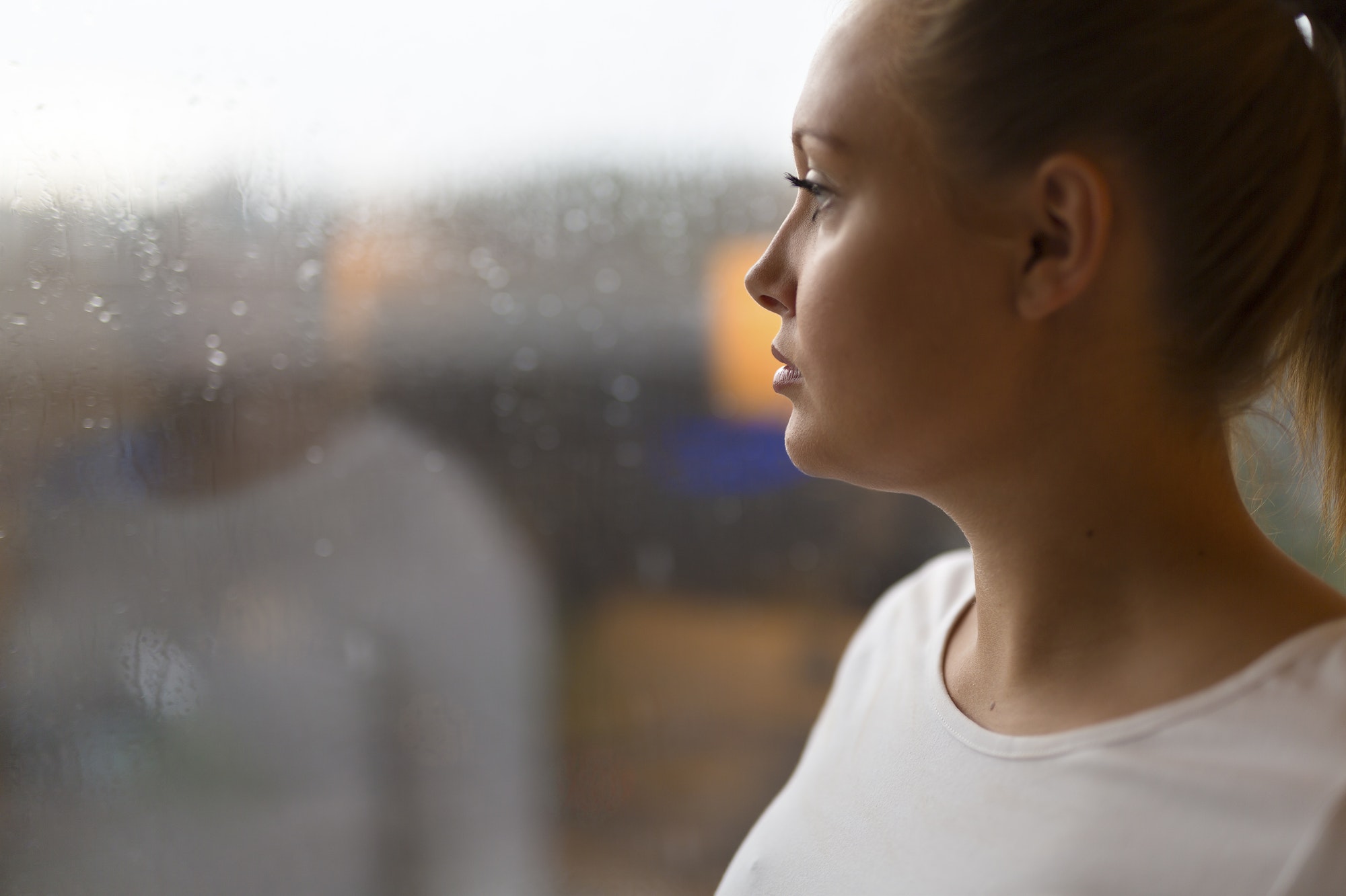 Thoughtful woman looking out the window